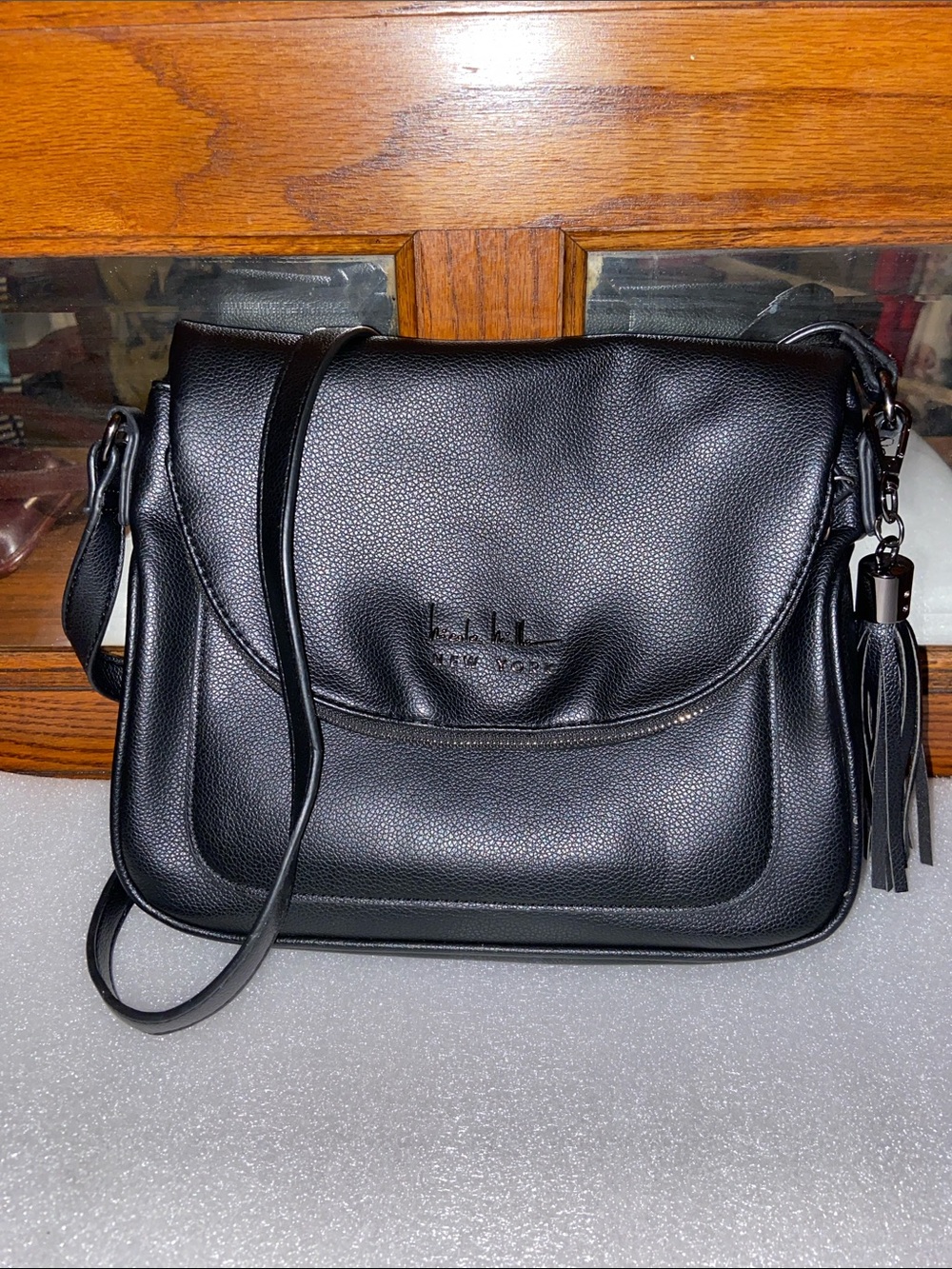 NWOT Nicole Miller Black Pebbled Faux Leather Crossbody Tassel Accent Flap Bag